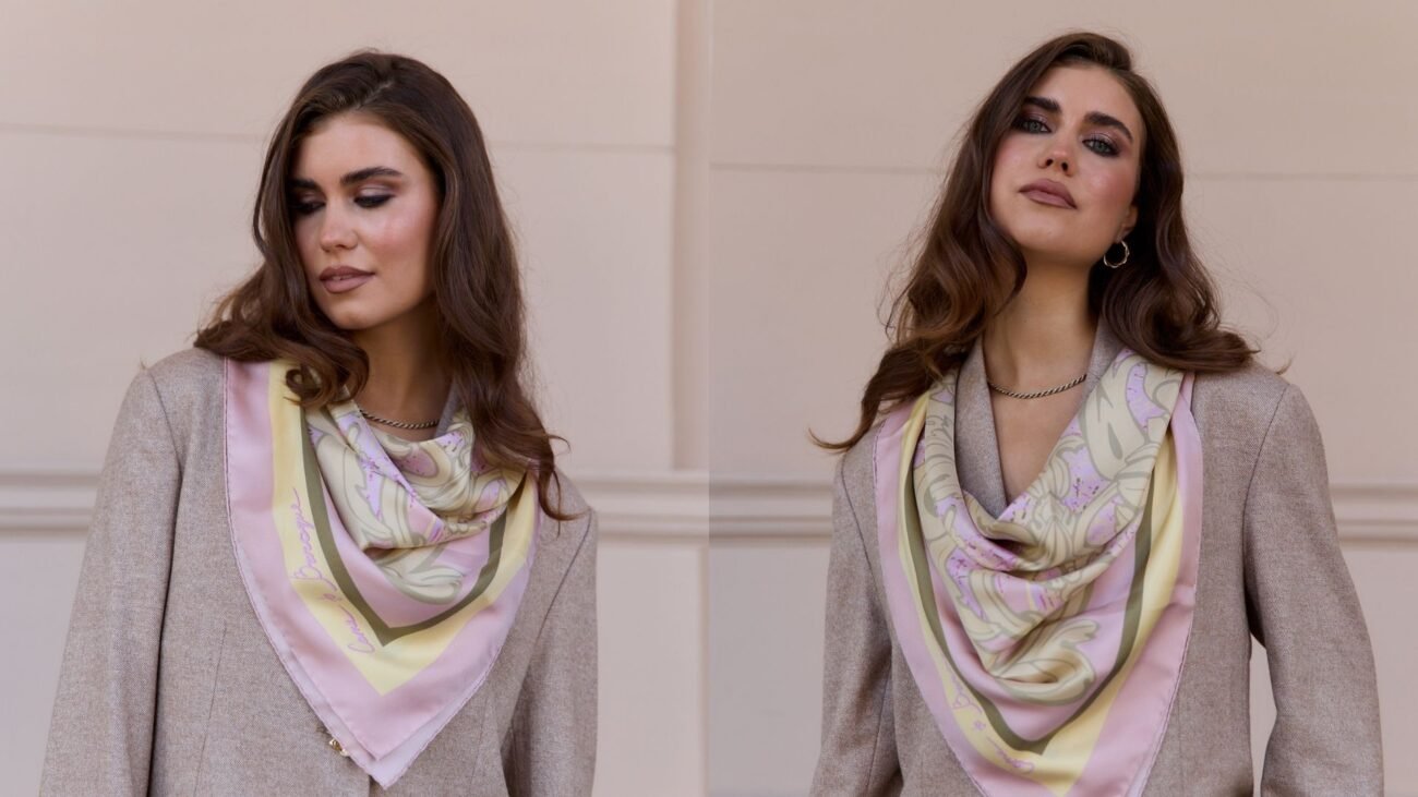 Square silk scarf worn as a triangle neckerchief over a blazer
