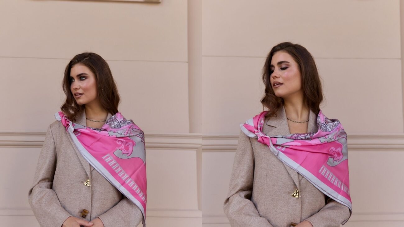 Pink silk scarf draped asymmetrically over one shoulder